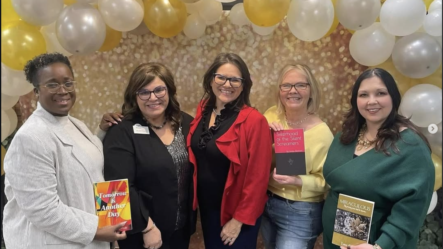 Meet Linsey Denham: Helping Women Find Their Way Back to Themselves 3 Meet Linsey Denham: Helping Women Find Their Way Back to Themselves - Standing with other authors holding her book: Sisterhood of the Silent Screamers